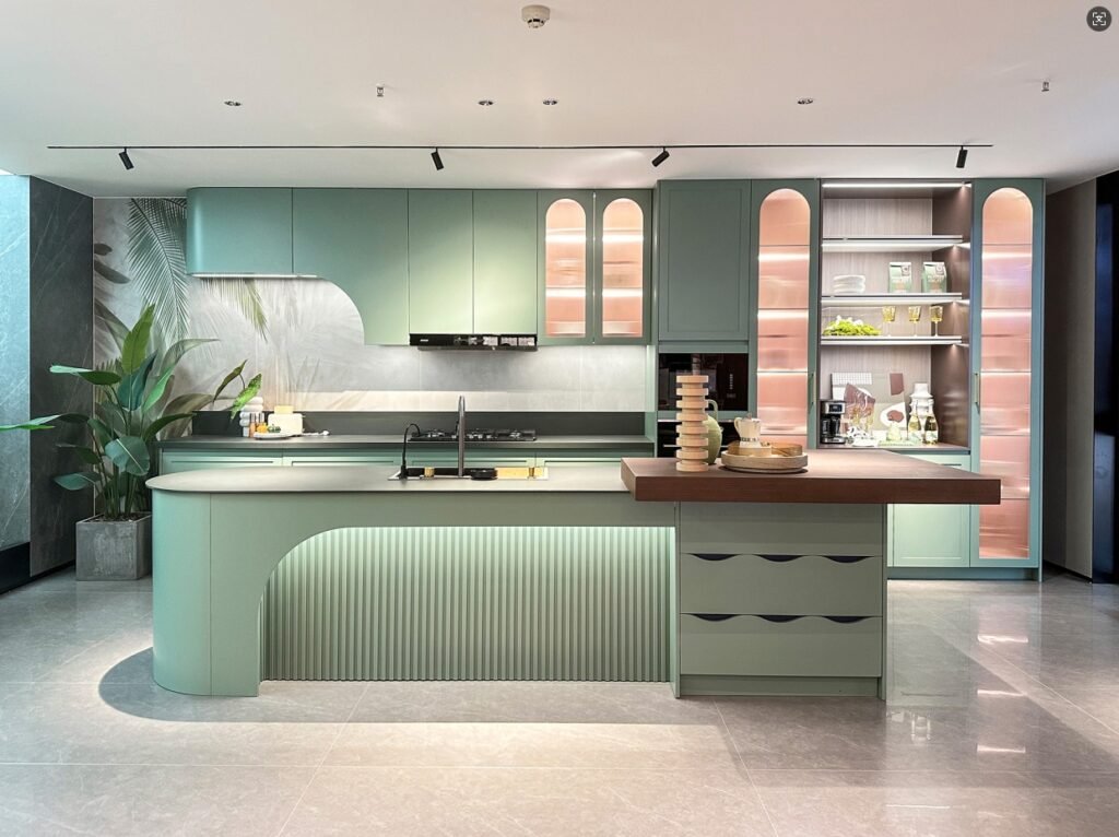 Modern kitchen with green cabinetry and integrated lighting, showcasing a clean and elegant design.
