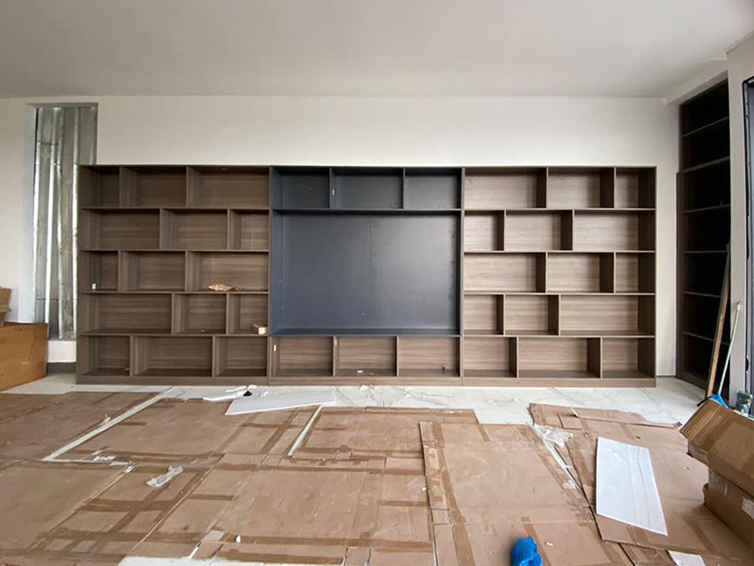 Indonesian home TV cabinet design with modern shelving in a geometric layout.