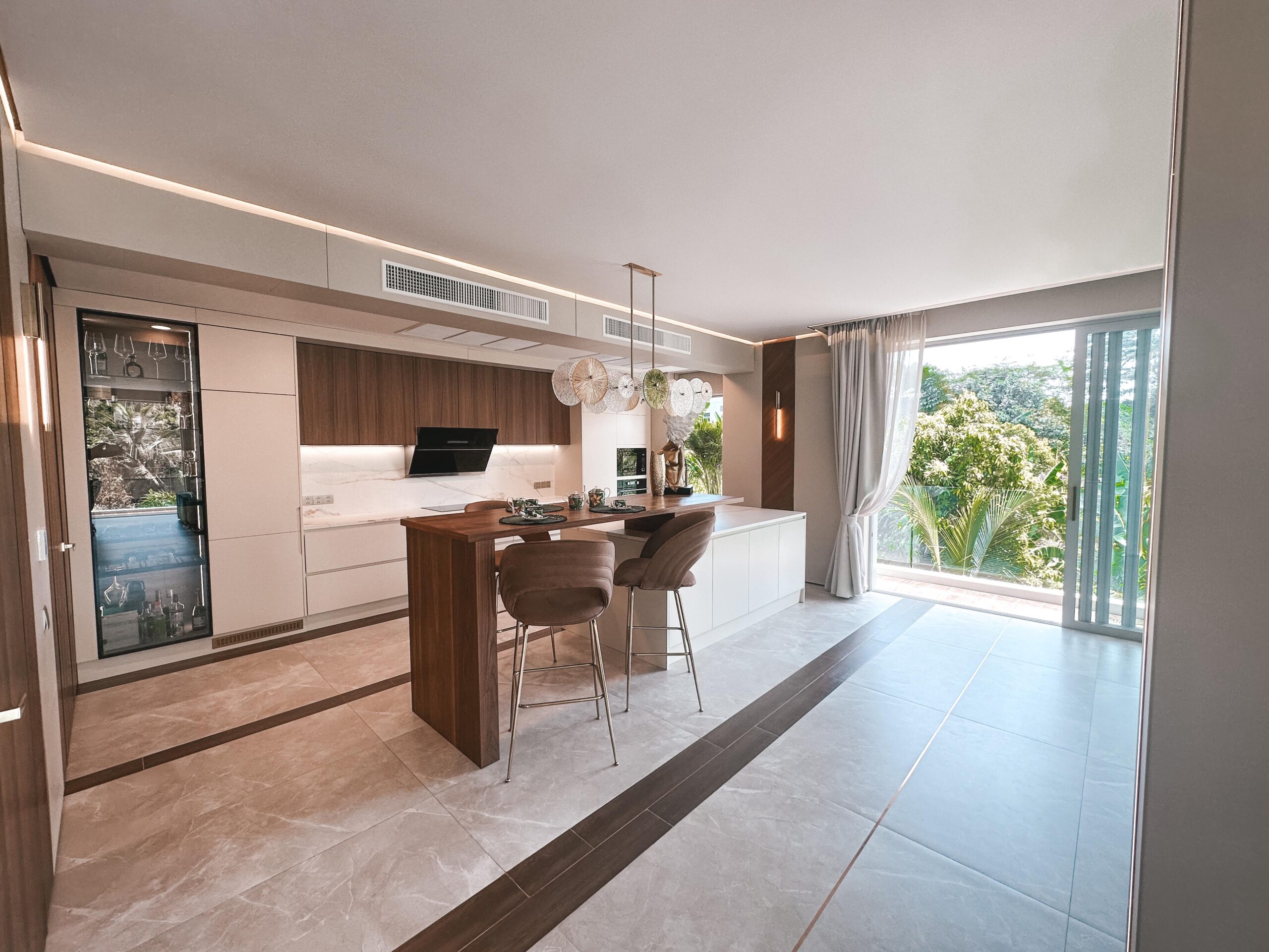 Modern custom kitchen cabinet design in a Thai home with clean lines and integrated appliances.