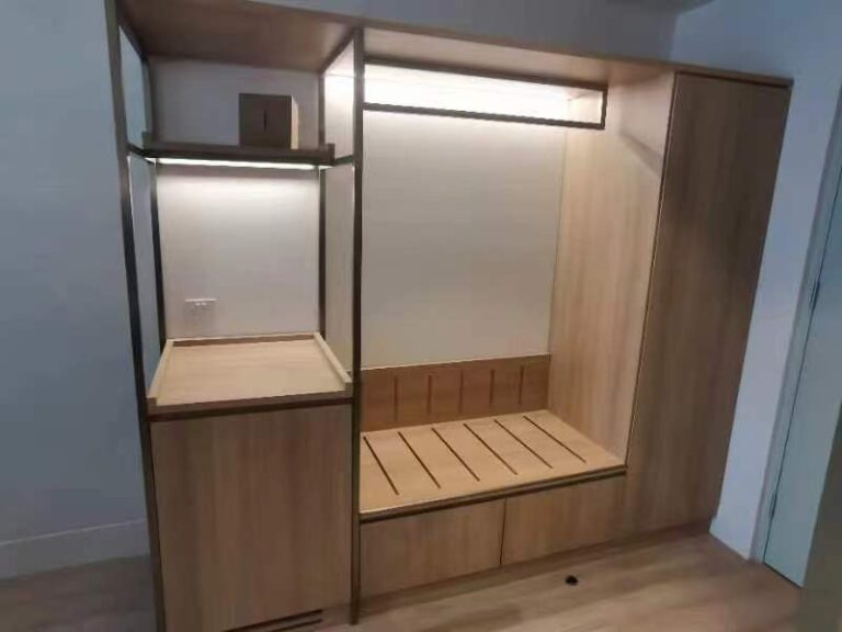 Custom wardrobe design in a Melbourne hotel featuring wood finishes and integrated lighting.