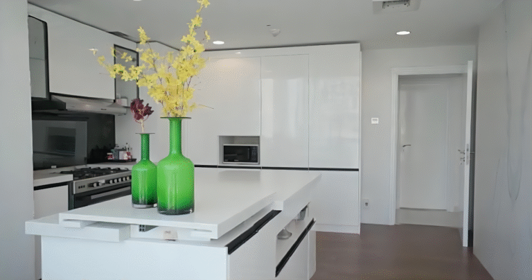 This Dubai luxury whole house custom project features a modern-style kitchen with frameless white cabinets, handleless doors, and a smooth surface. The white kitchen island adds to the clean and elegant design.