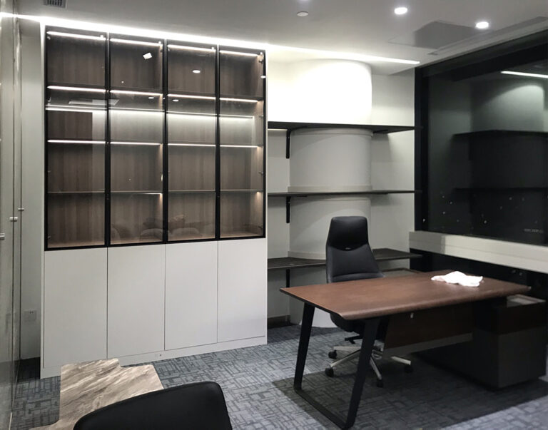 office cabinet with glass-front doors and LED shelf lighting in Indonesian corporate workspace