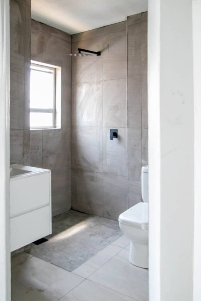 48 Sets Custom Cabinets for Ongwe Holiday Apartment in Namibia 9 Modern bathroom design with shower and white cabinet in Ongwe Apartment project.