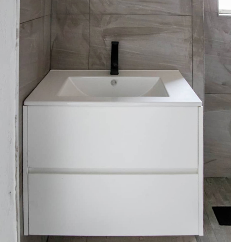 48 Sets Custom Cabinets for Ongwe Holiday Apartment in Namibia 8 Custom bathroom vanity with sleek black faucet in Ongwe Apartment bathroom.