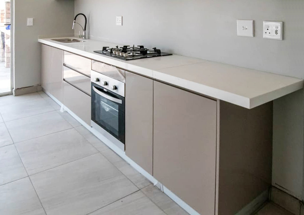 48 Sets Custom Cabinets for Ongwe Holiday Apartment in Namibia 2 Top view of kitchen cabinets with white counter in Ongwe Apartment.