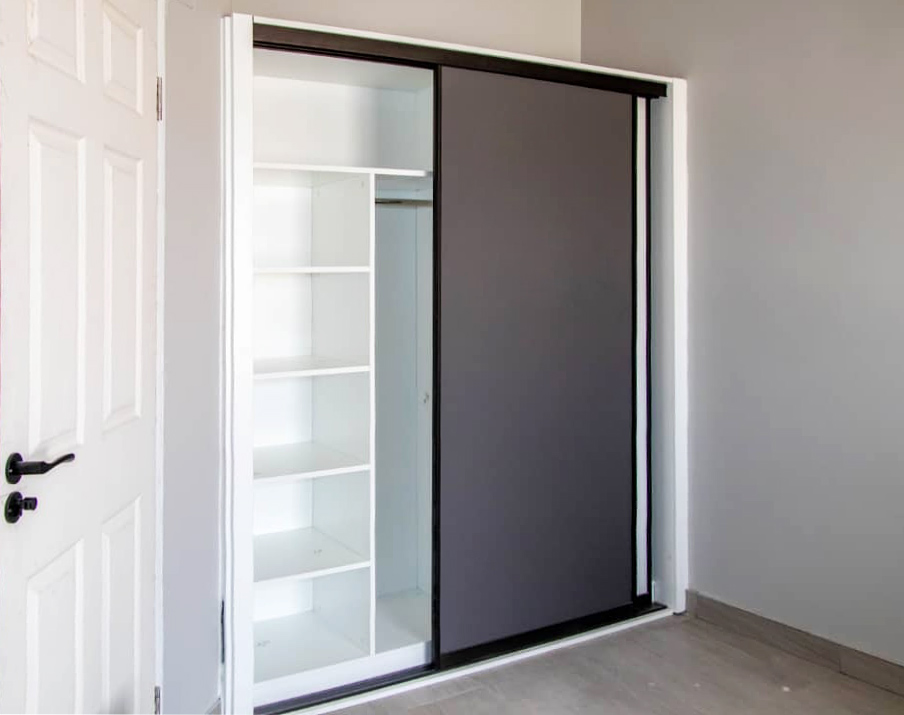 48 Sets Custom Cabinets for Ongwe Holiday Apartment in Namibia 5 Modern wardrobe with sliding doors and efficient storage in Ongwe Apartment.