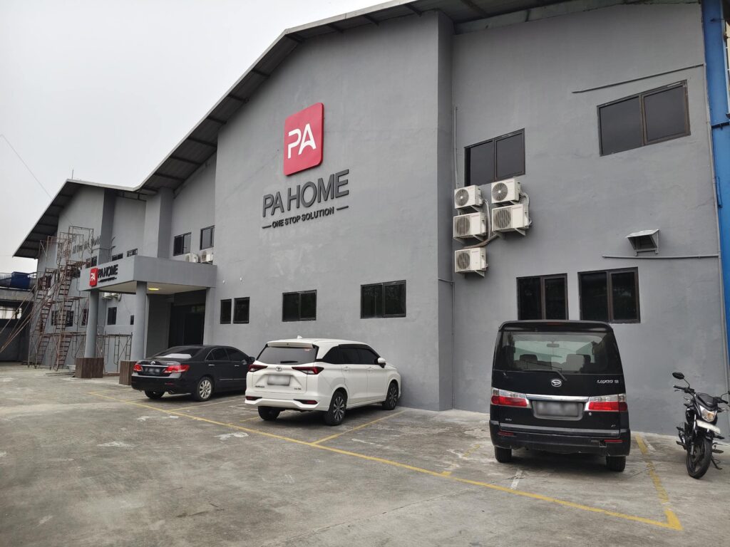 PAhome Indonesia local kitchen cabinet factory exterior with branded signage and parked vehicles