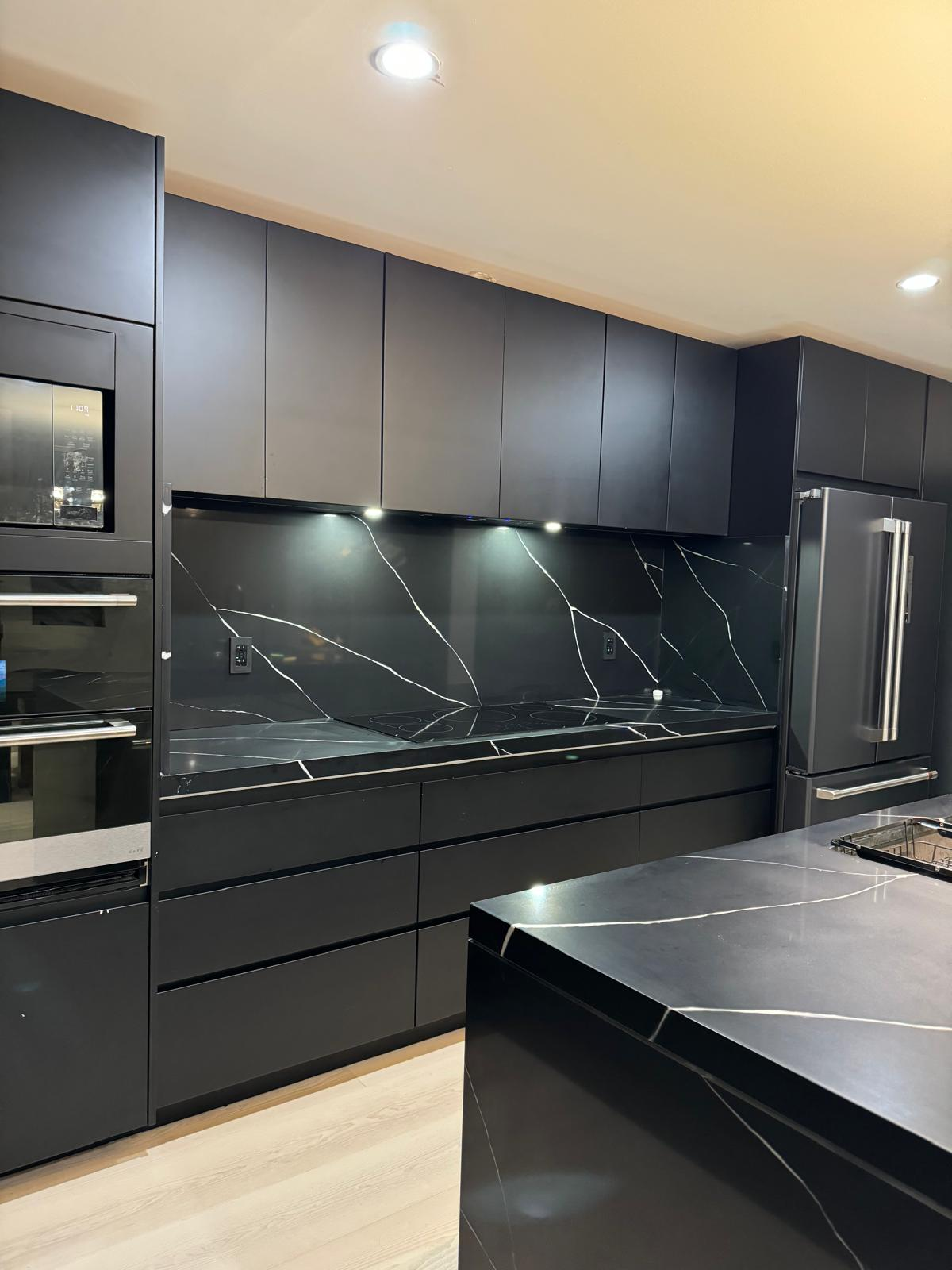 Custom cabinet in Los Angeles kitchen with black finish and high-end appliances.