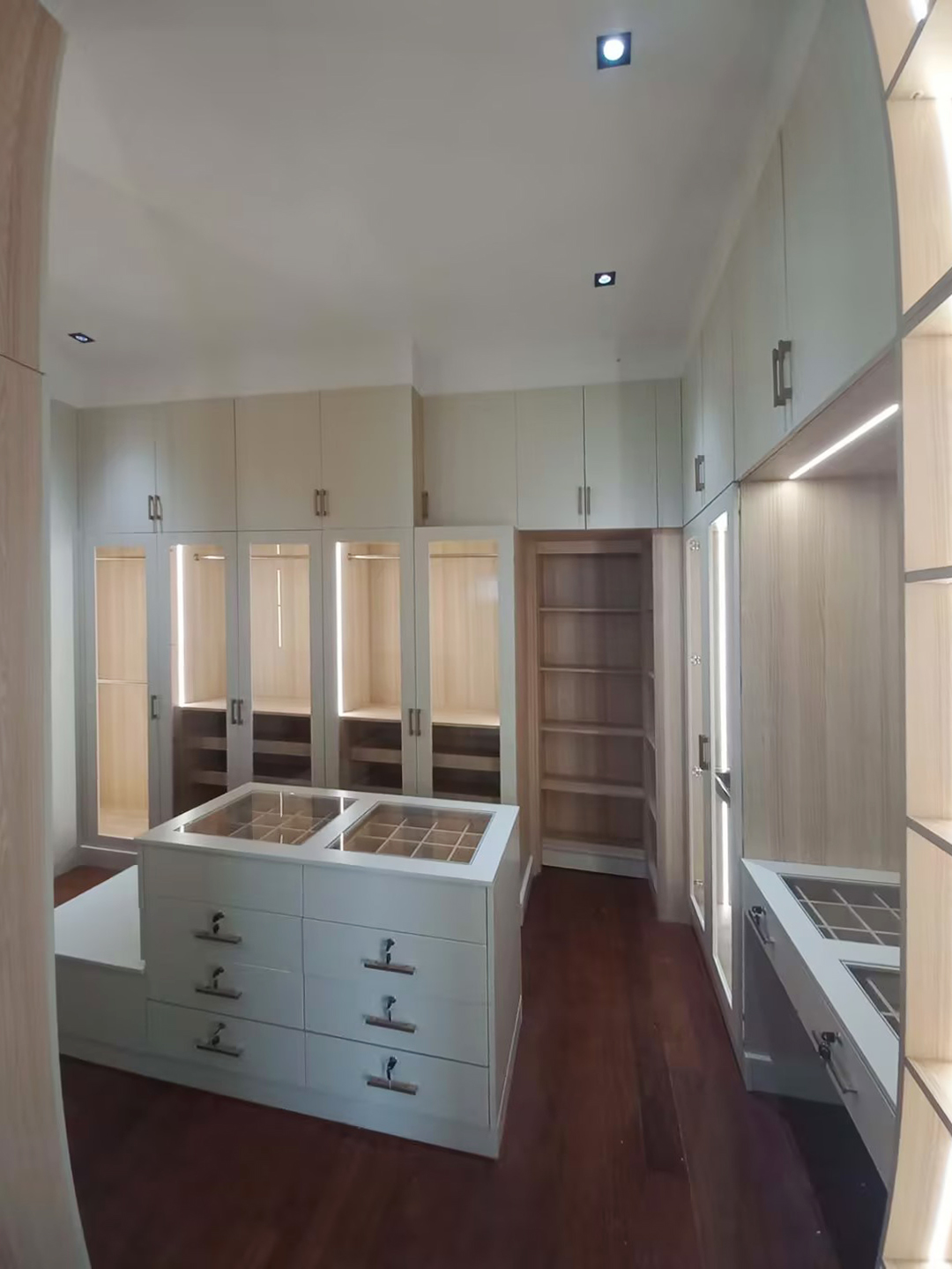 Walk-in closet with custom wooden cabinets in Whole House Custom in Philippines project.