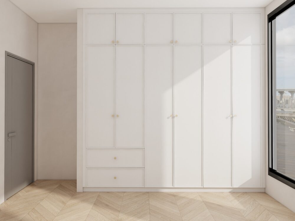 Sleek white built-in bedroom wardrobe with full-height doors and upper cabinets