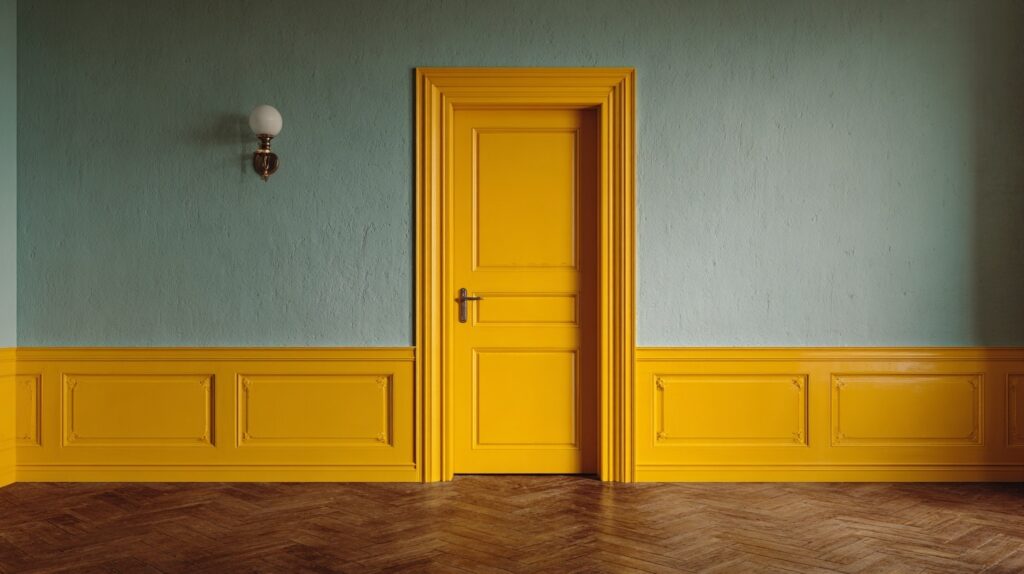 A mustard yellow interior door brightens the room, adding a vibrant and playful touch to the modern decor.