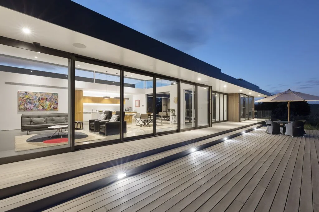 Modern villa with open glass sliding doors and outdoor deck
