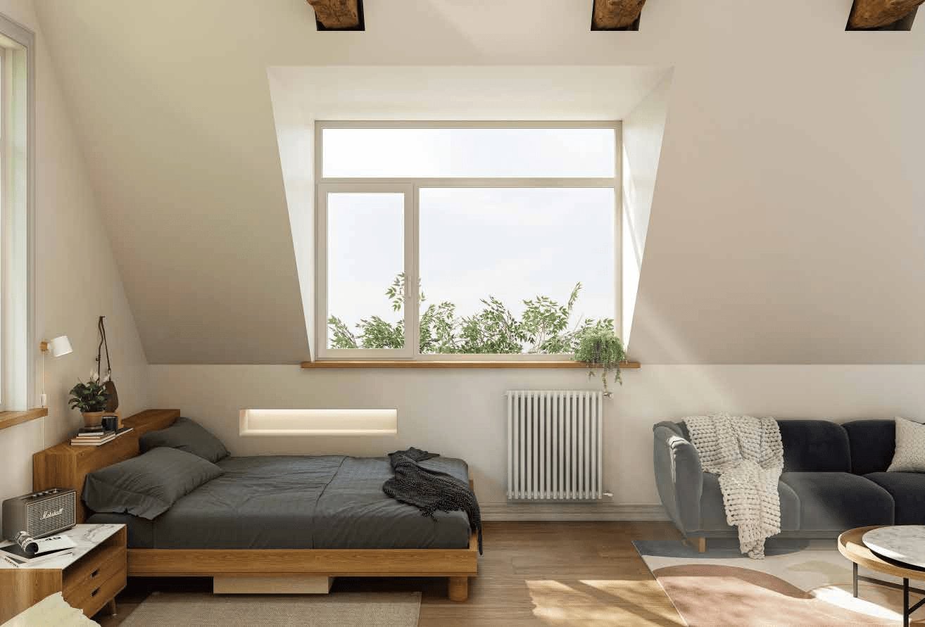 Bright attic bedroom with sloped ceilings and exposed wood beams, featuring a large white aluminium casement window divided into two opening sections, providing a view of green treetops.