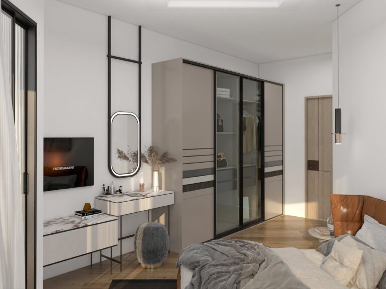 Modern bedroom interior featuring a large taupe and glass sliding door wardrobe, a coordinated white fluted TV console with marble top, and an oval vanity mirror, creating a sleek, integrated storage and dressing area.