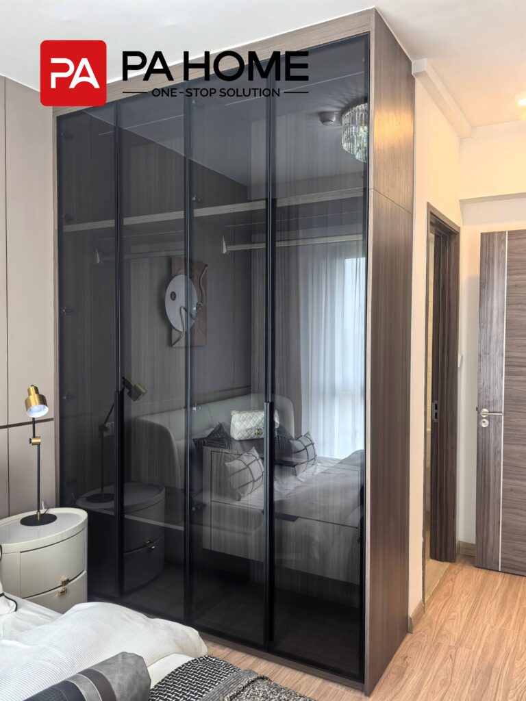 Elegant Tangerang Whole House Custom Interior Project 4 Tangerang bedroom with custom glass door wardrobe, wood frame, dark glass panels, and modern storage.
