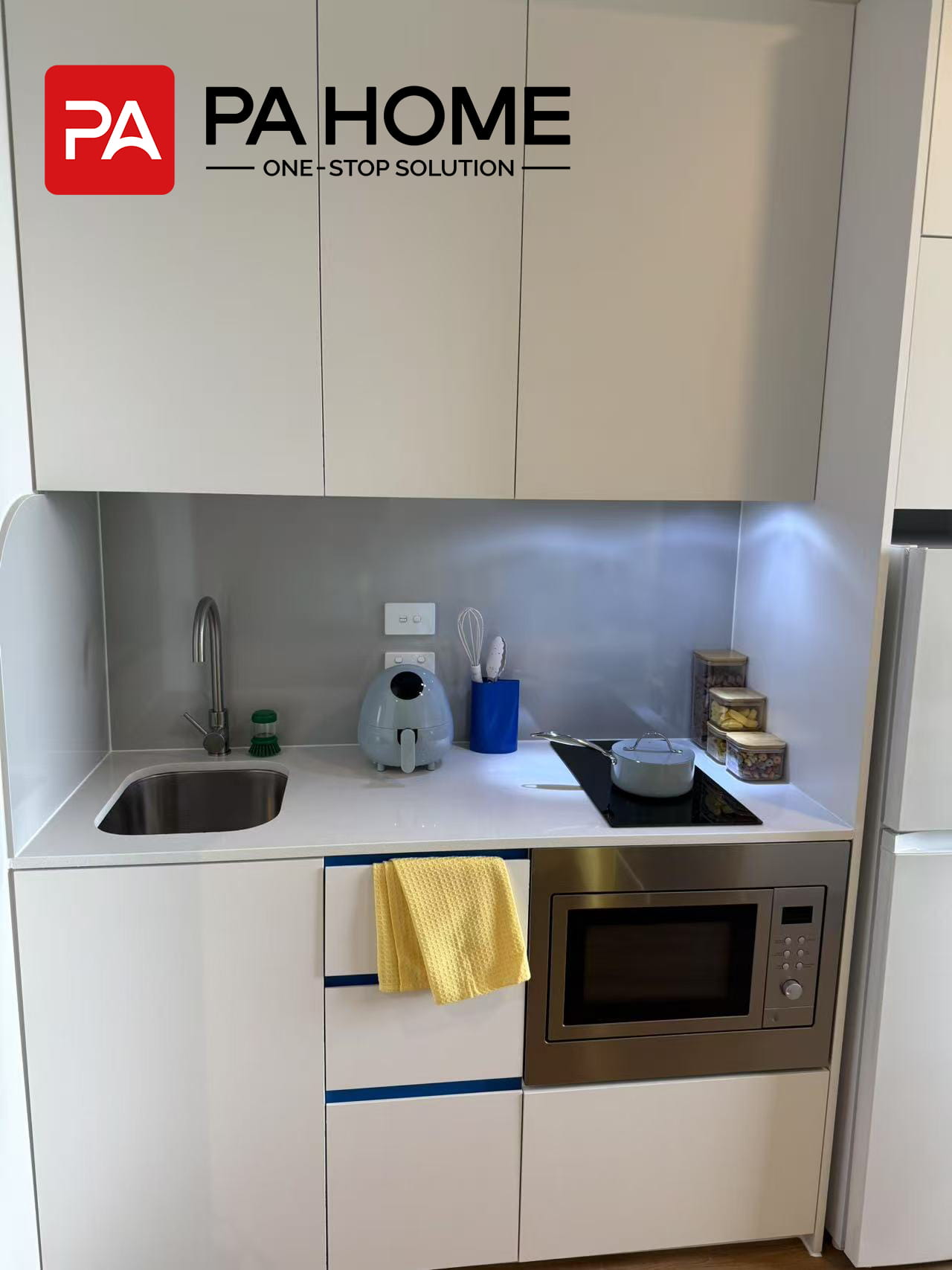 Custom Furniture & Cabinetry for 308-Unit Student Apartment Project in Sydney 5 Custom kitchen cabinet in a Sydney student apartment with modern appliances and built-in equipment.