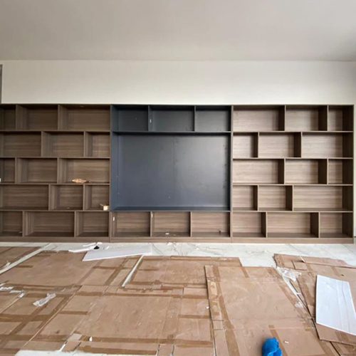 Indonesian home TV cabinet design with modern shelving in a geometric layout.