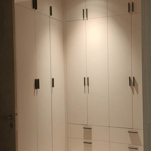 Indonesia Full House Customization - Custom wardrobe design in a bedroom with light wood and sleek finishes.