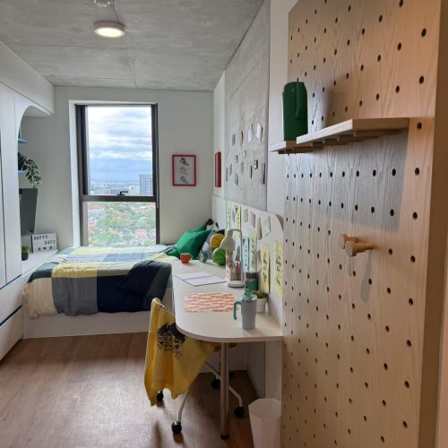 Custom bedroom wardrobe in a student apartment in Sydney with a modern design and open storage.