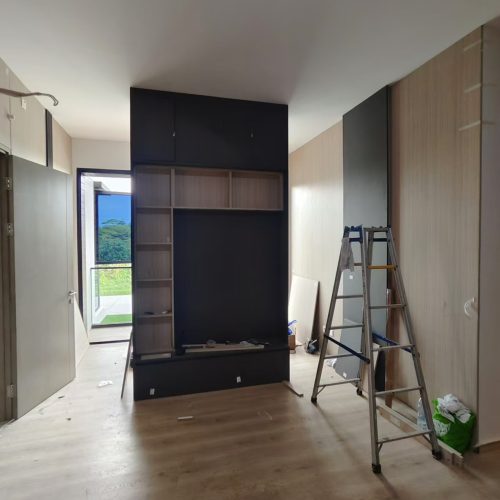 In the Indonesian Full House Customization Project, one side of a room has a custom cabinet and wall panels