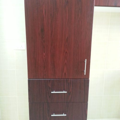 This Abu Dhabi whole house custom project features custom storage cabinets with a red cherry wood veneer, adding a rich and elegant touch to the space.
