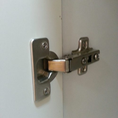The cabinet hardware includes sturdy, reliable hinges designed for long-lasting durability, ensuring smooth operation and extended use.