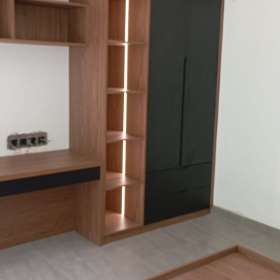 floating walnut storage cabinet with black drawer and open shelving next to study nook
