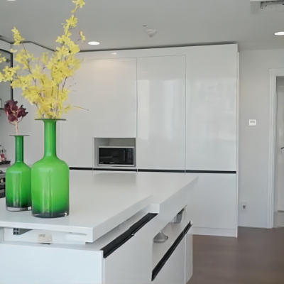 This Dubai luxury whole house custom project features a modern-style kitchen with frameless white cabinets, handleless doors, and a smooth surface. The white kitchen island adds to the clean and elegant design.