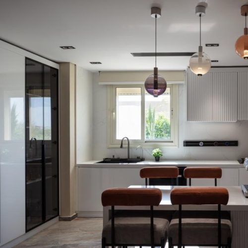 Bright kitchen with white cabinetry and black countertops, Egypt whole house customization