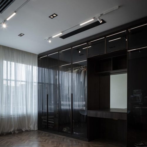 Custom wardrobe with glass doors and integrated lighting in Egypt whole house customization