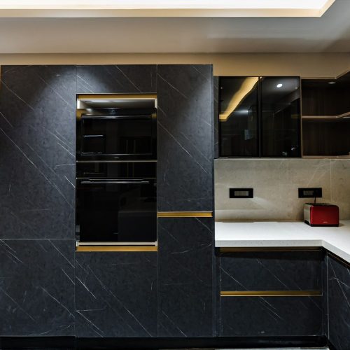 India Whole House Customization kitchen with dark cabinetry and marble countertop