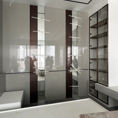Elegant custom mirrored room cabinets in a spacious bedroom with a clean, modern design.