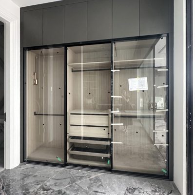 Custom wardrobe with transparent glass doors in a mirrored room style, designed for the bedroom.