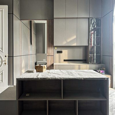 Walk-in closet with custom mirrored room design and modern cabinetry.
