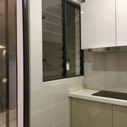 Two‑burner induction cooktop under white overhead cabinets with stainless steel range hood