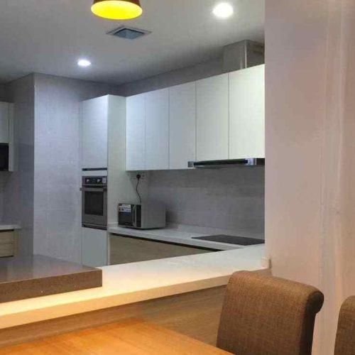 Open pass‑through kitchen counter overlooking dining area with adjoining workspace