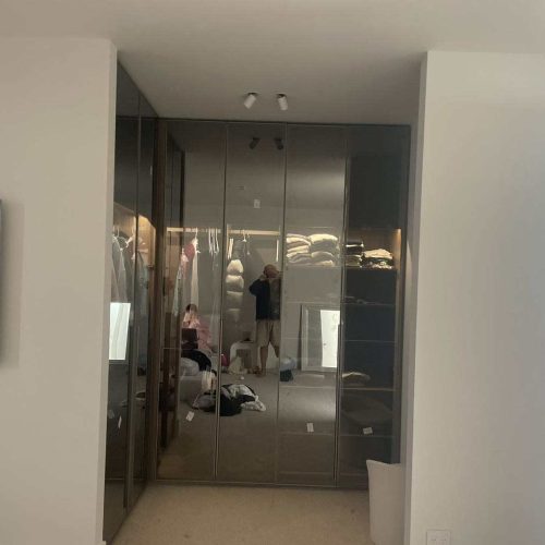 Melbourne's high-end whole house customization wardrobe with sleek mirrored doors and modern interior lighting