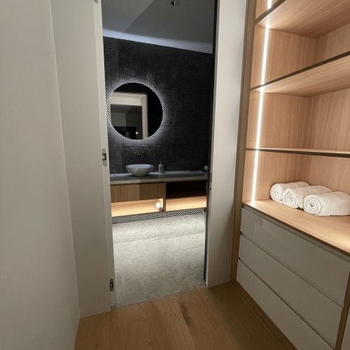 Luxury Whole House Custom in Melbourne 13 timber-lined-doorway-view-into-illuminated-vanity-shelving