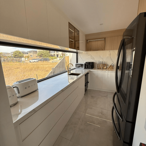 Luxury Whole House Custom in Melbourne 5 galley kitchen with marble countertop and timber-accent cabinets
