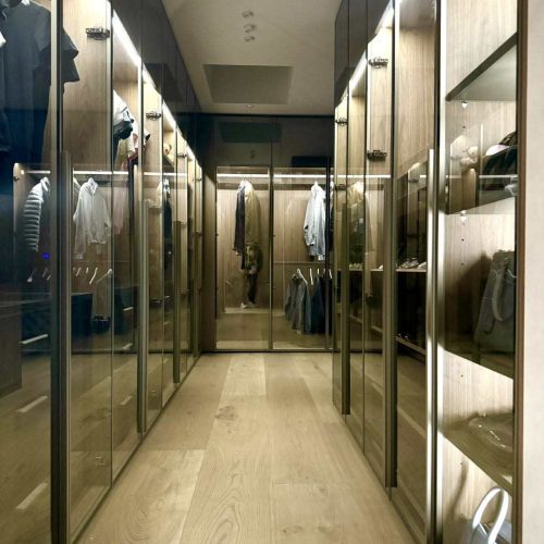 Melbourne's high-end whole house customization luxurious walk-in closet with wooden panels and LED lighting