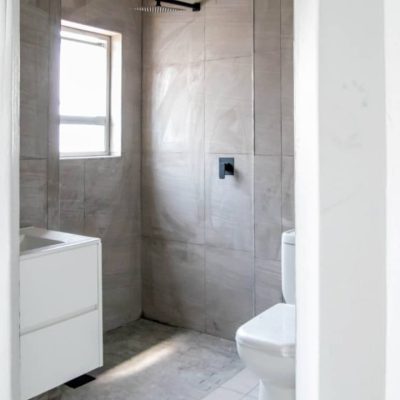Modern bathroom design with shower and white cabinet in Ongwe Apartment project.