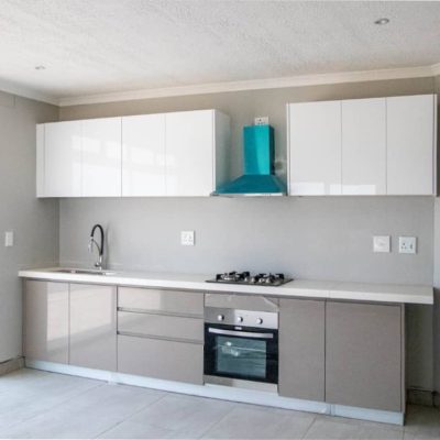 Ongwe Apartment kitchen cabinets with ample storage space and a modern design.