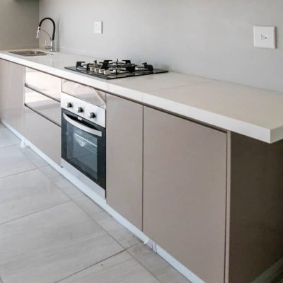 Top view of kitchen cabinets with white counter in Ongwe Apartment.