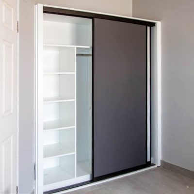 Modern wardrobe with sliding doors and efficient storage in Ongwe Apartment.
