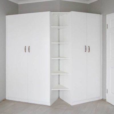 Interior of custom wardrobe with shelves and hanging space in Ongwe Apartment.