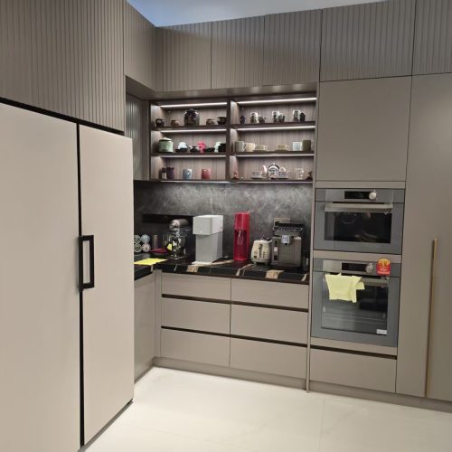 Corner kitchen cabinets with built-in ovens, refrigerator compartment, and under-shelf lighting