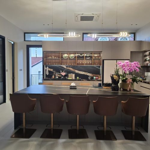 Sleek marble kitchen island with leather bar stools and pendant lighting