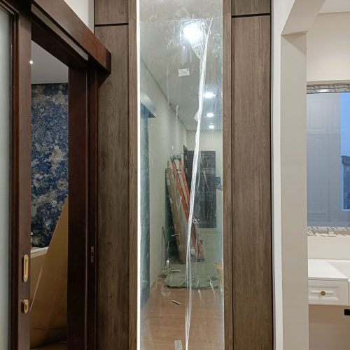 South Jakarta custom cabinets featuring a tall mirror with integrated lighting.