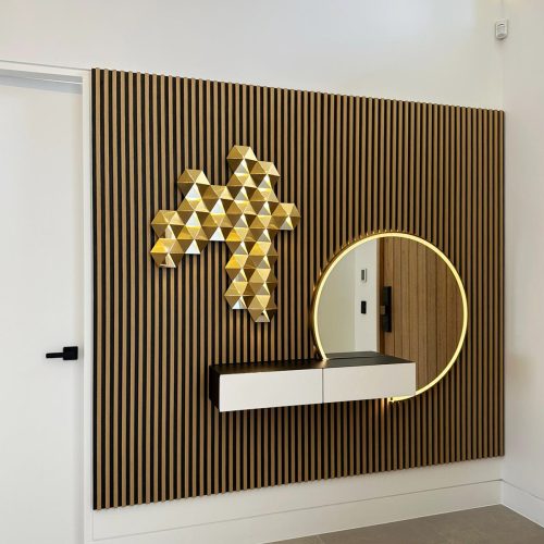 geometric brass art installation on timber panel wall
