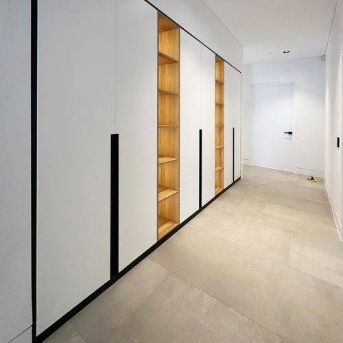 Minimal panelled custom wardrobe with open oak niches
